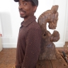 Thami Kiti posing next to a work in progress -