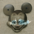 Global Celebrity, 2002. Cement, collage and perspex on board, 22 x 27 cm. (Image courtesy of the artist).