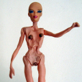 Structurally Adjusted Barbie, 2014. Various plastics, epoxy resin, steel, soot, 19- 26 cm. (Image courtesy of the artist).