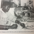 Avhashoni Mainganye, an AIA/UNISA first year fine art student demonstrates his skills to a young visitor