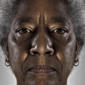 Faces of people who may or may not be victims or perpetrators of domestic violence (Lucy), 2013. Pigment ink on cotton Baryta, 68 x 140 cm (Photo courtesy of artist)