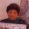 Vakalisa - Joan Baker, writer, with paintings by Kenny Baker (photo: courtesy Mervyn Davids)